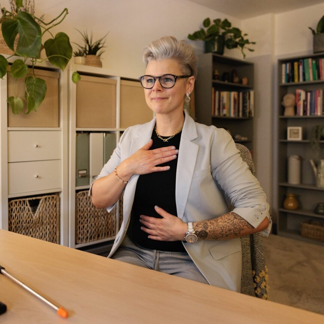 A woman in glasses is sitting at the table