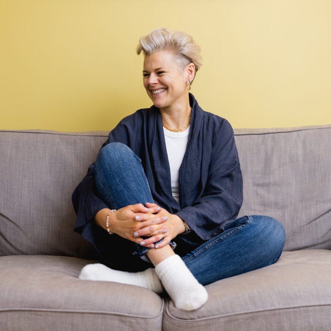 A woman sitting on top of a couch.