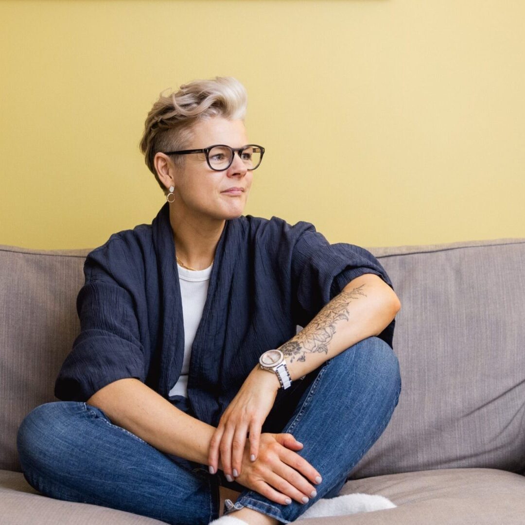 A woman sitting on top of a couch.